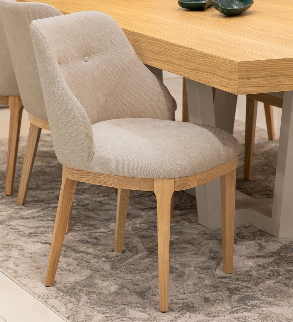 Chair upholstered in fabric, with wooden feet.