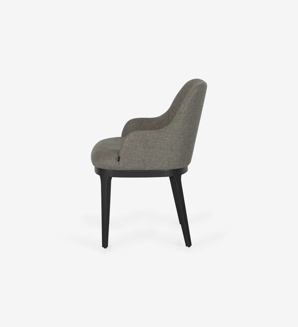 Chair with armrest upholstered in fabric, with wooden feet in black laquered.