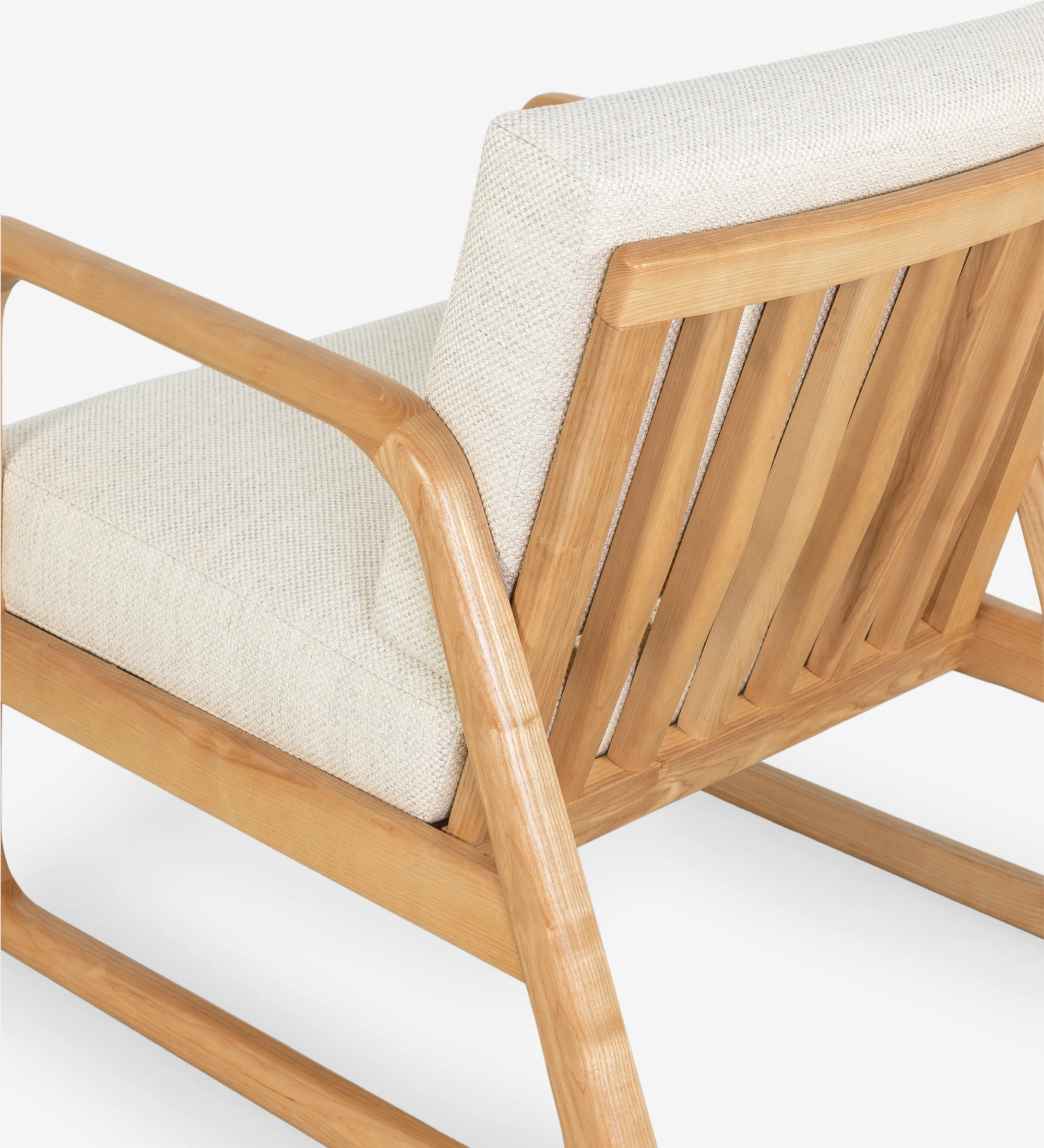 Fauteuil Antarte by IA recouvert en tissu beige, structure en bois naturel.