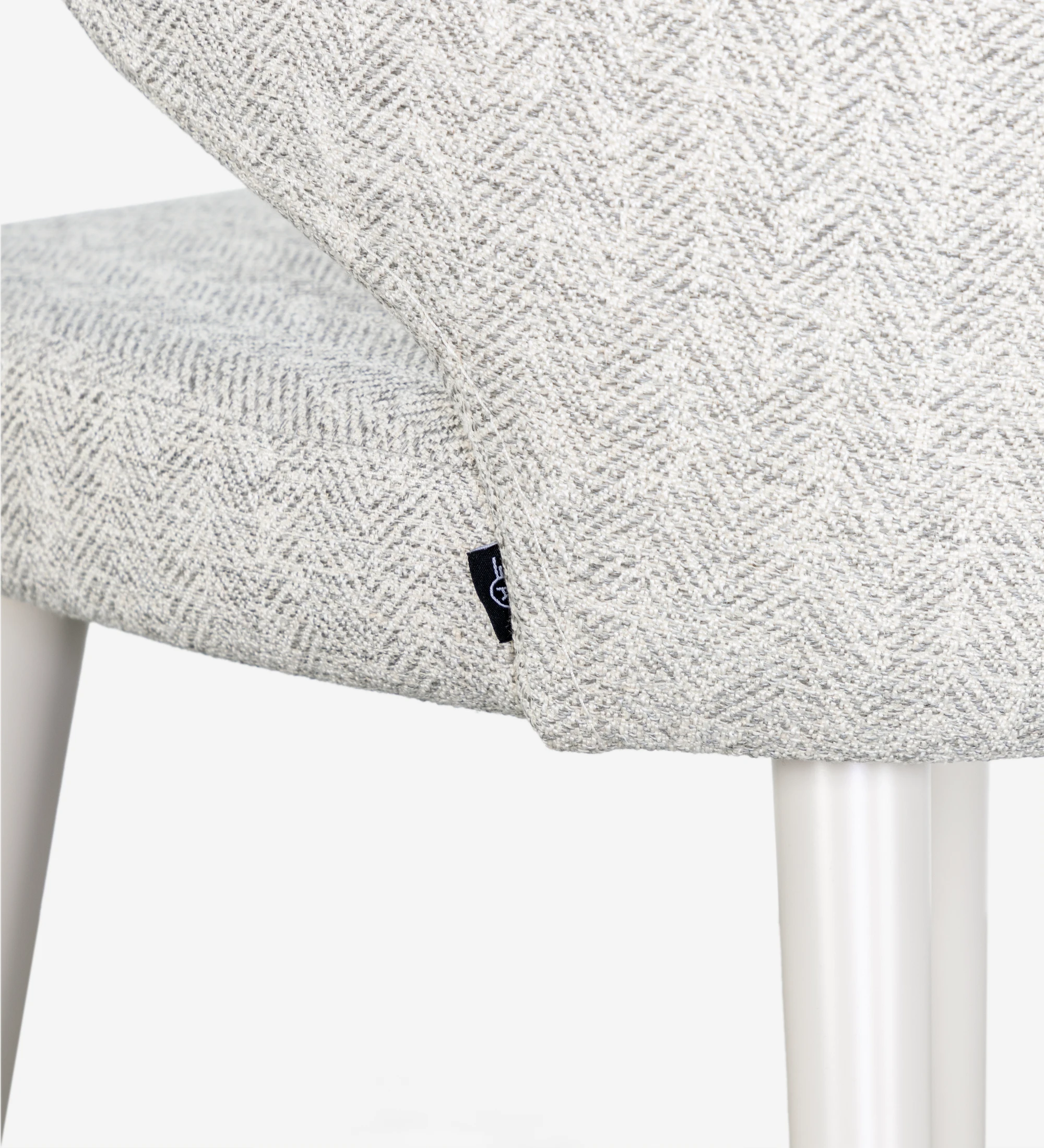 Chair upholstered in fabric, feet lacquered in pearl.