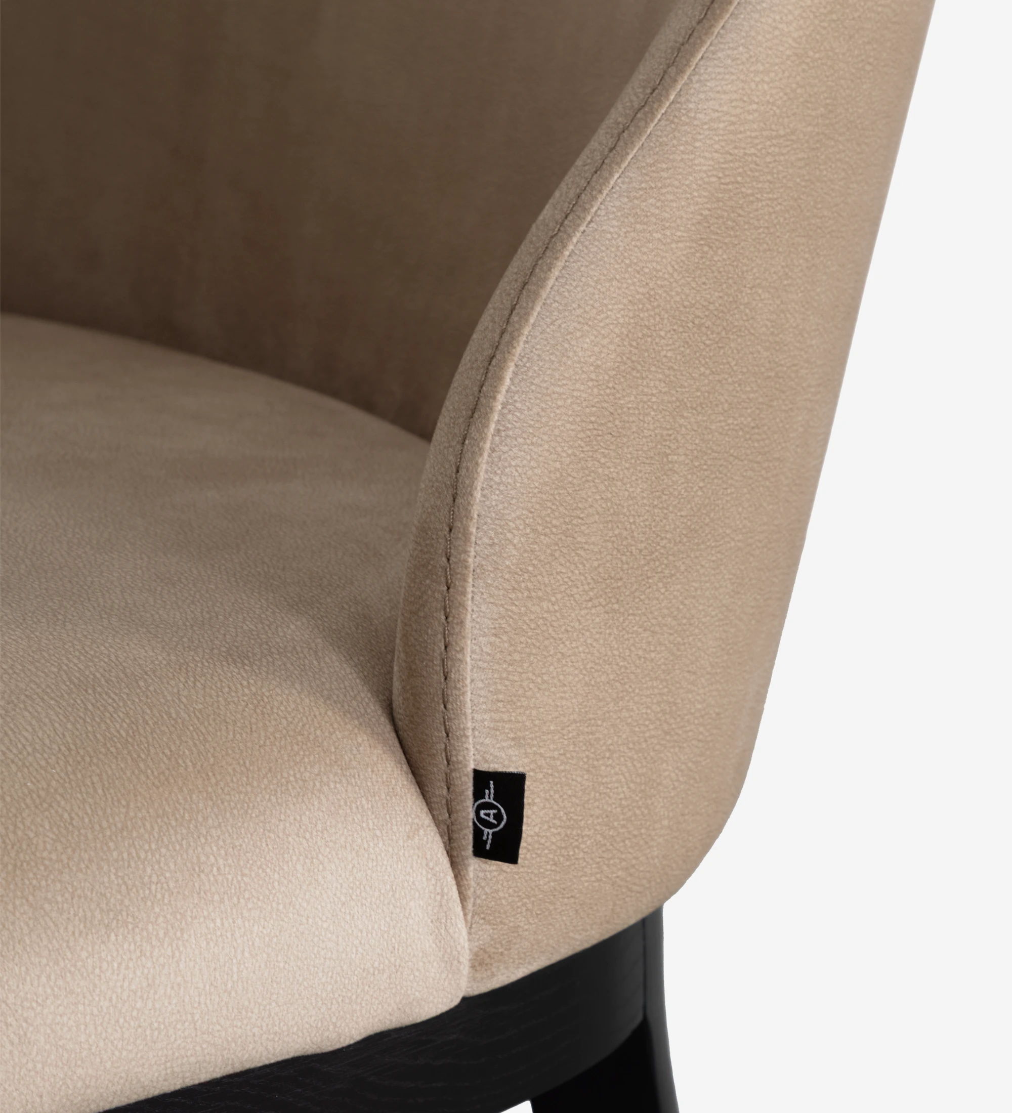 Chair upholstered in toffee fabric, with black lacquered wooden feet.