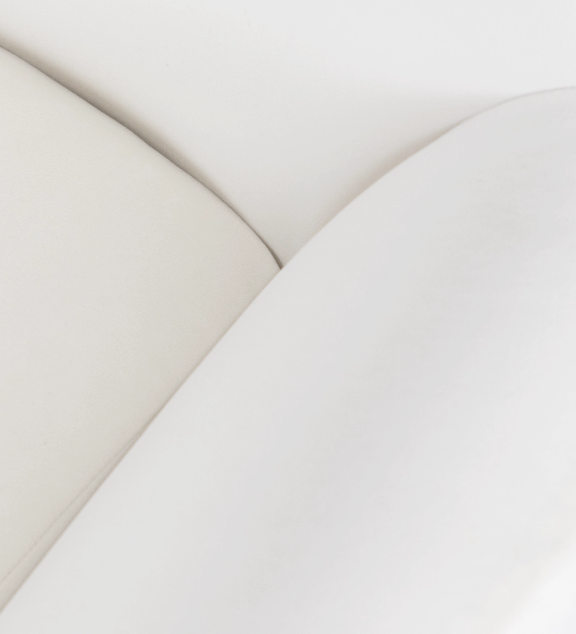 Oslo armchair upholstered in pearl fabric with walnut-stained ash wood legs.