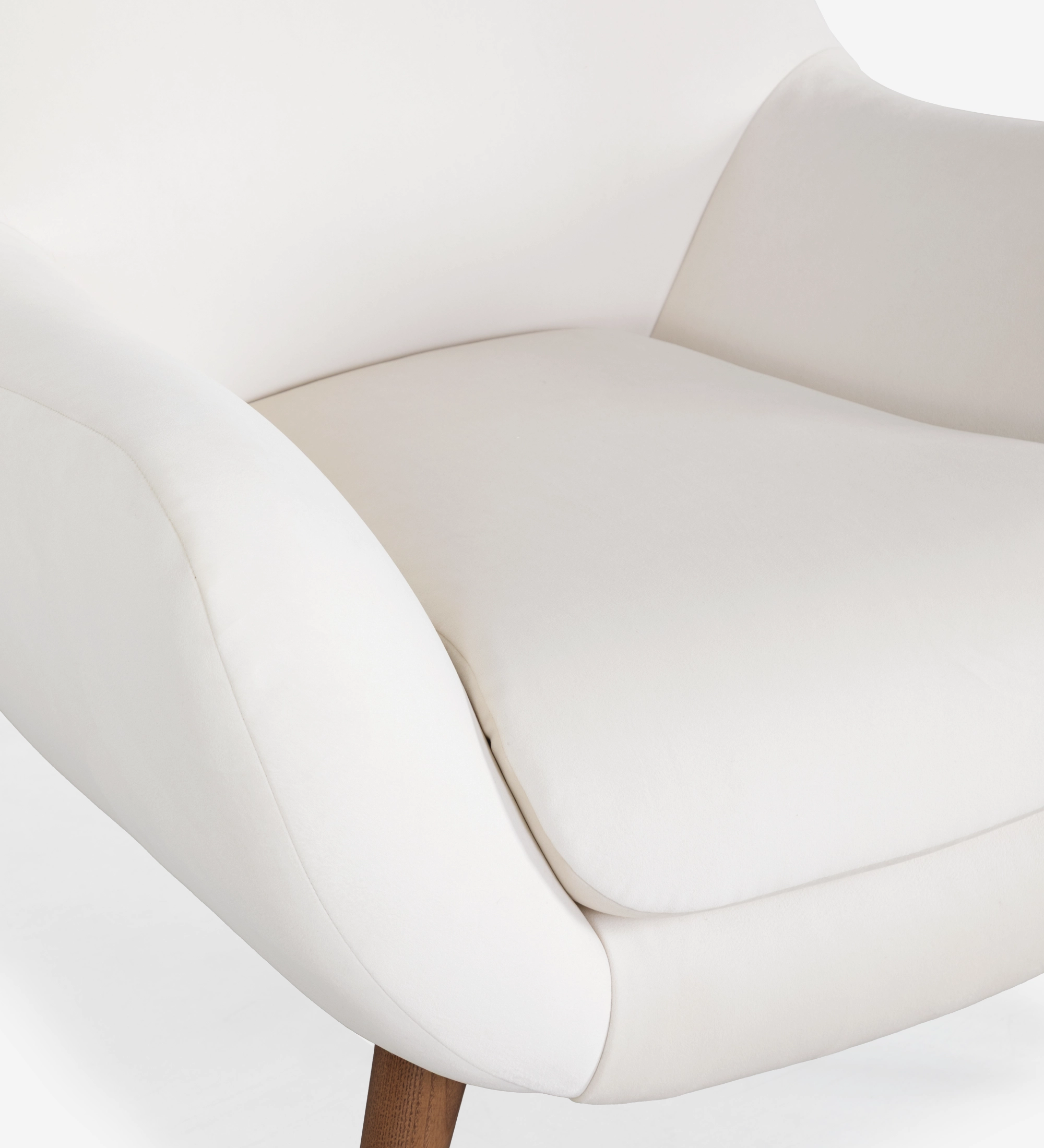 Oslo armchair upholstered in pearl fabric with walnut-stained ash wood legs.