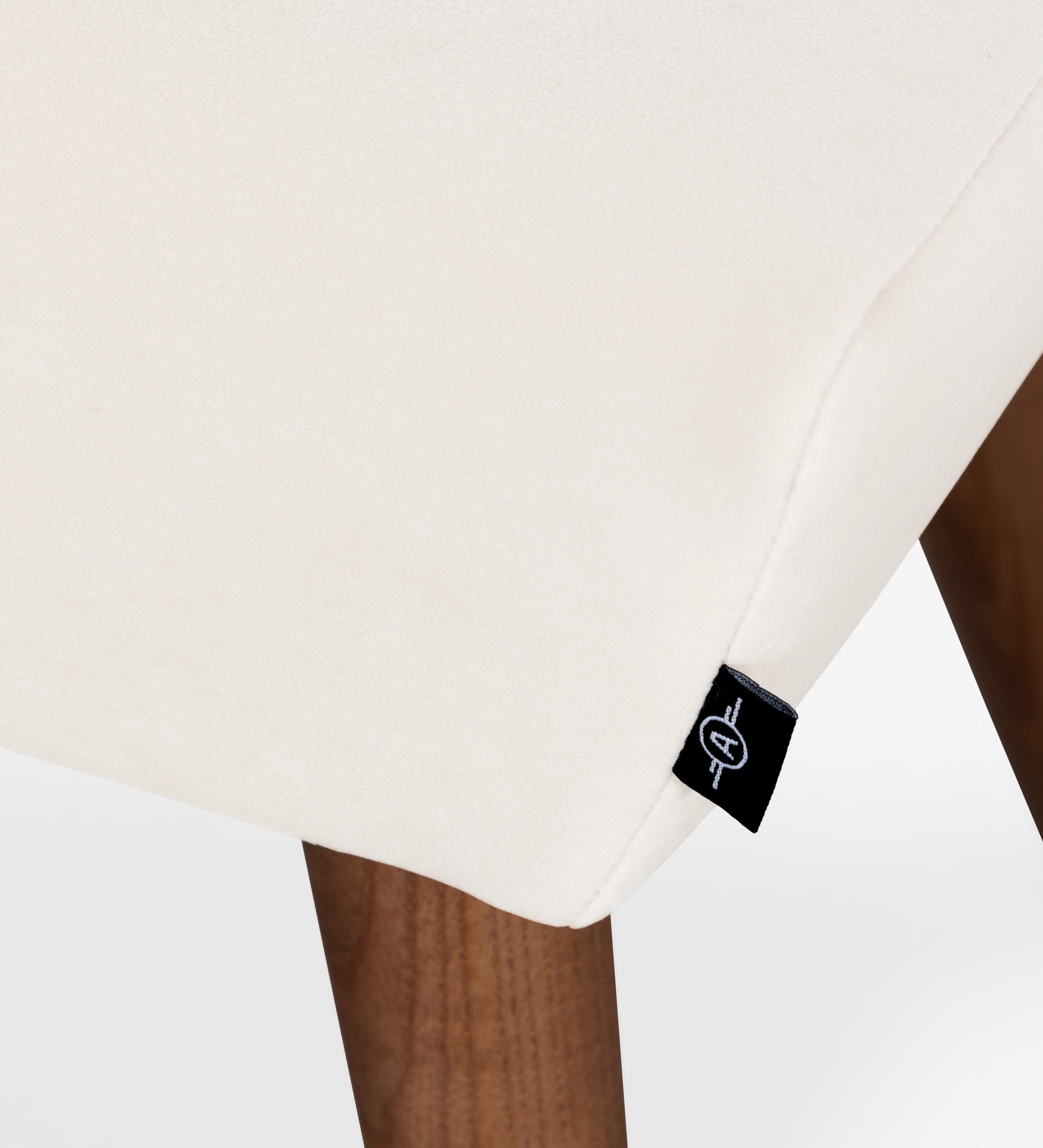 Upholstered in pearl fabric with walnut-colored ash wood legs.