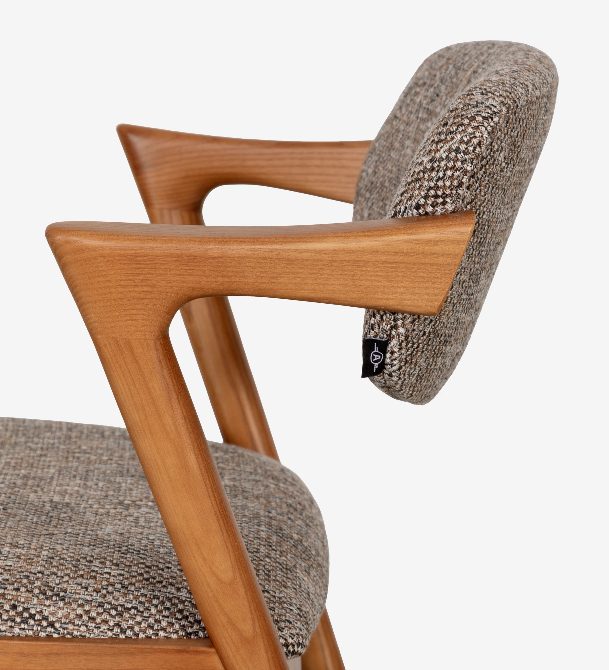Silla de madera de fresno color miel, con asiento y respaldo tapizados en tejido multicolor, principalmente en tonos marrones y beige.