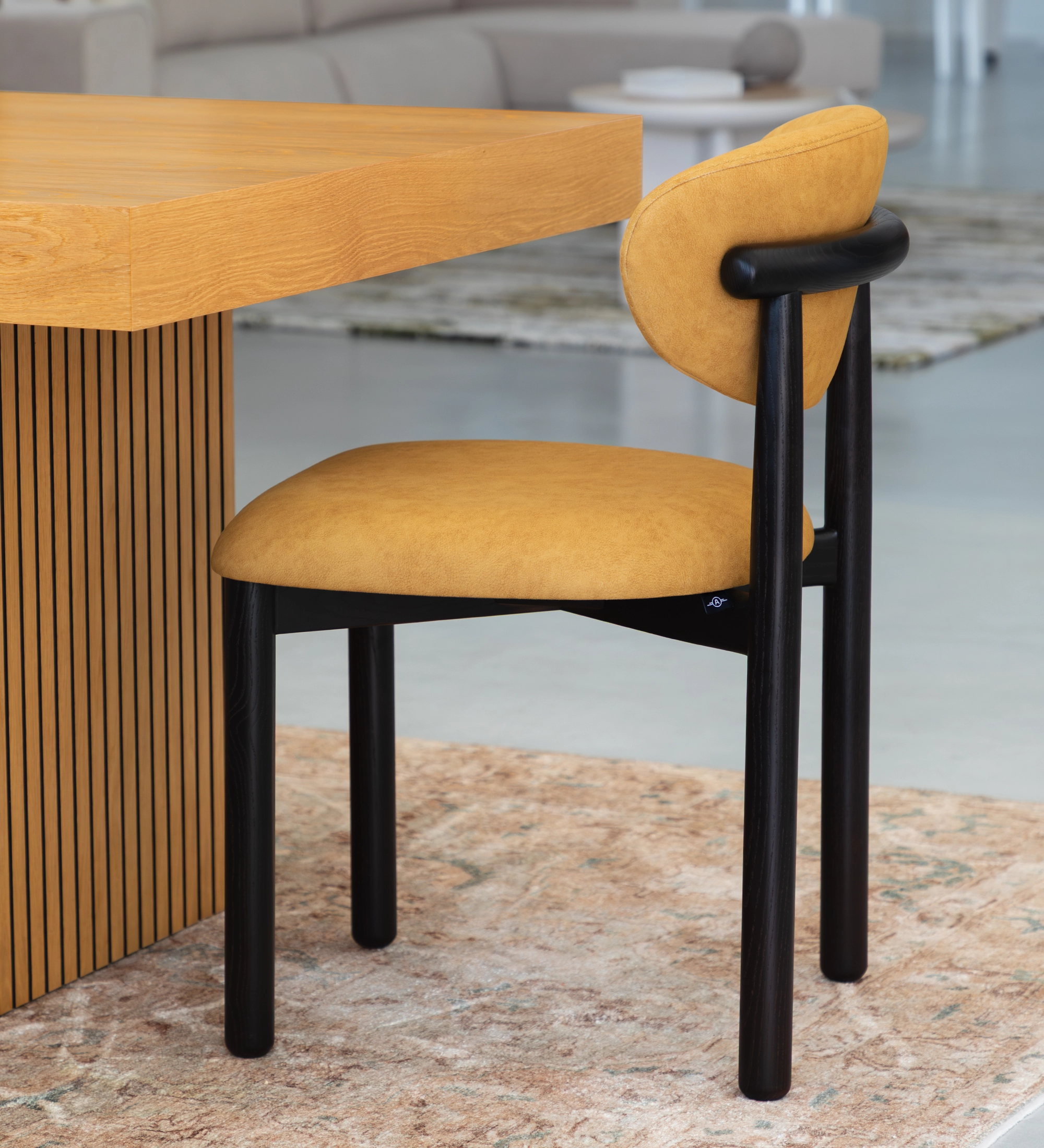 Ash wood chair in wenge color, with seat and backrest upholstered in yellow fabric.