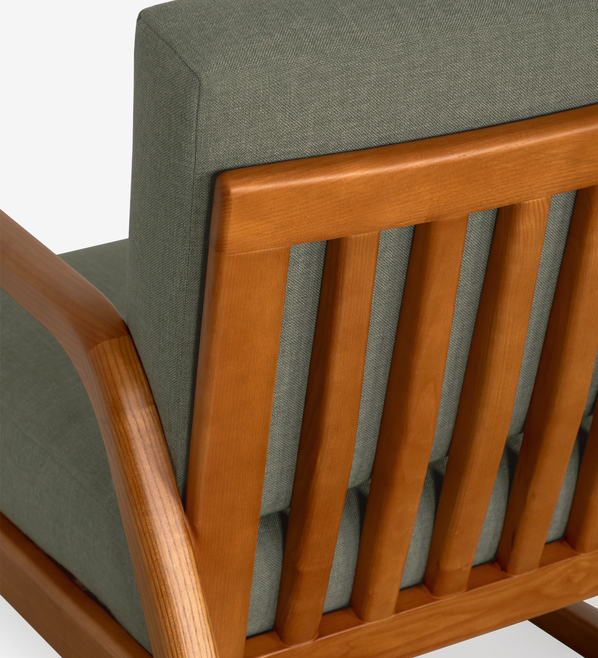 Sillón Antarte by IA tapizado en tela verde, estructura en madera color miel.