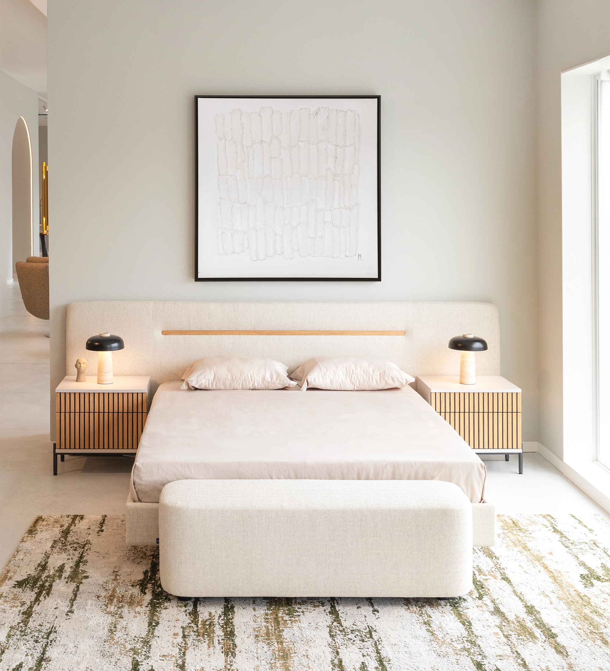 Double bed with upholstered headboard and suspended base in beige fabric, detailed in natural oak.