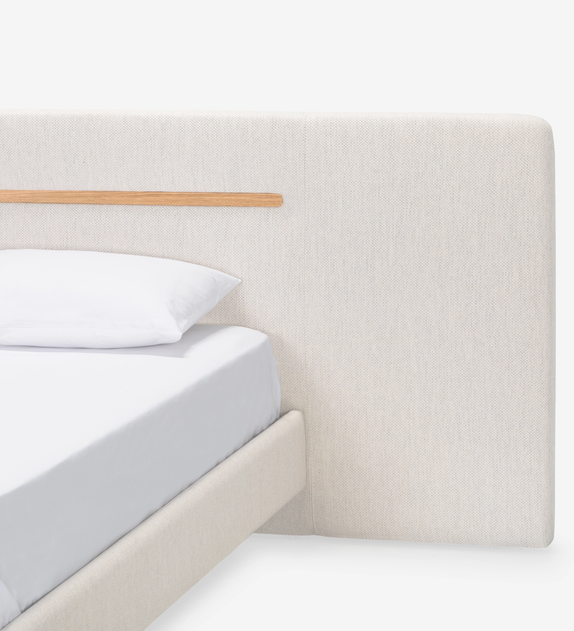 Double bed with upholstered headboard and suspended base in beige fabric, detailed in natural oak.