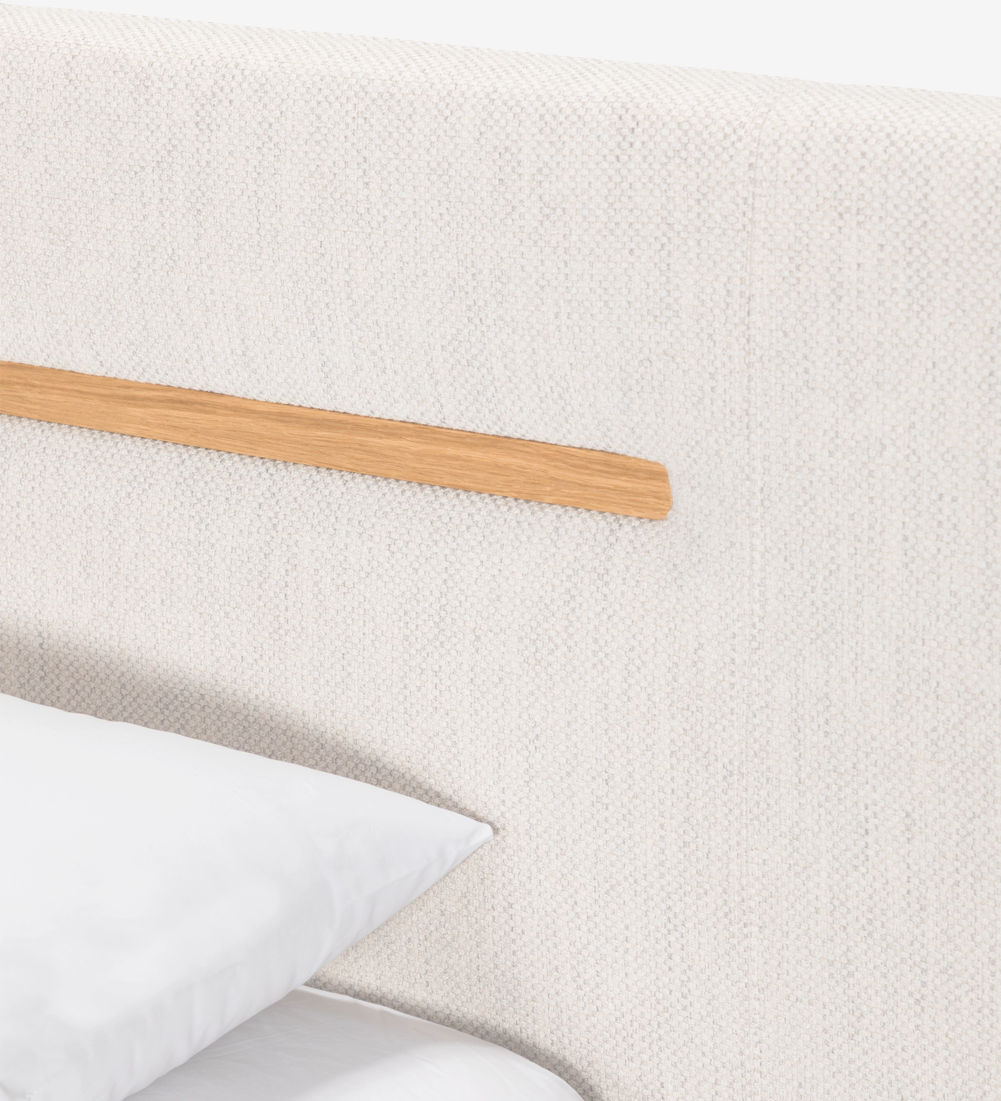 Double bed with upholstered headboard and suspended base in beige fabric, detailed in natural oak.