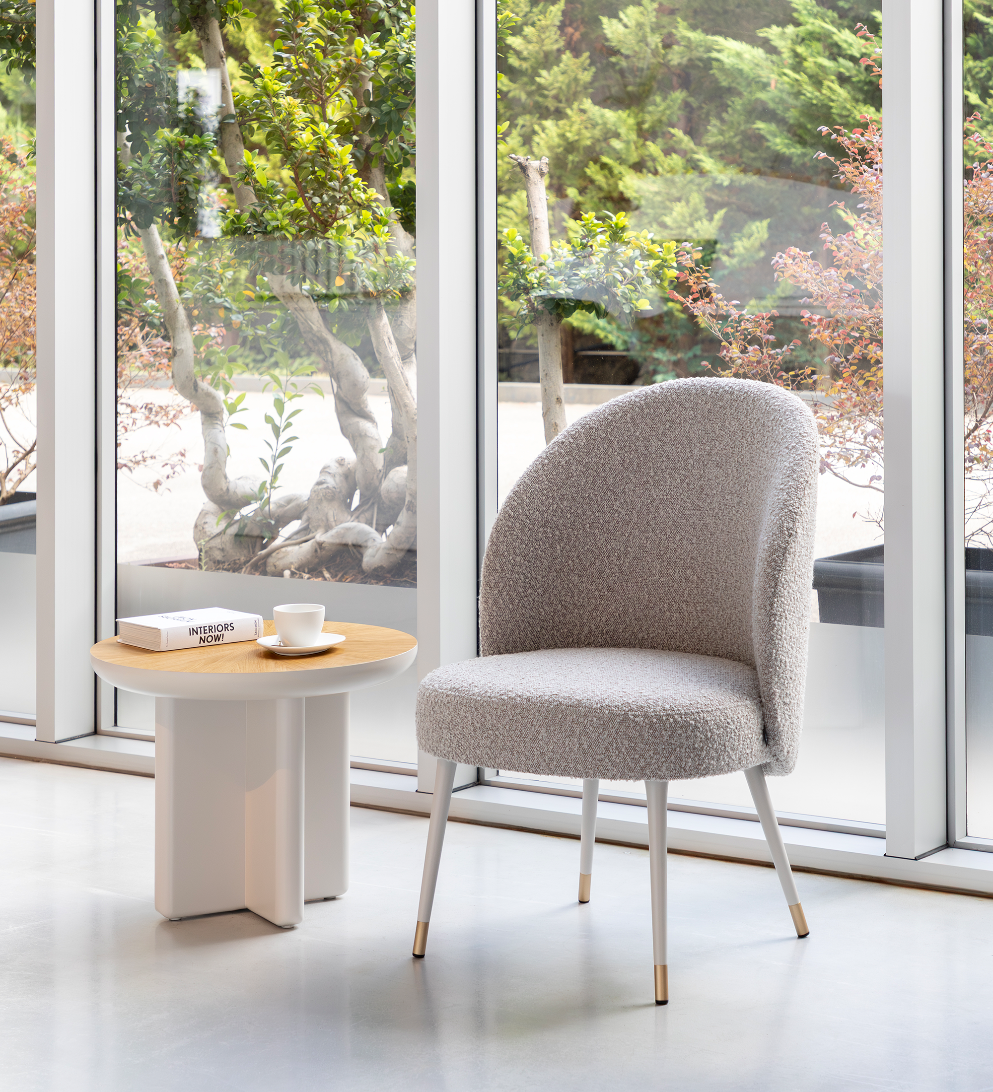 Geneve armchair upholstered in toffee fabric, pearl lacquered feet and golden detail.