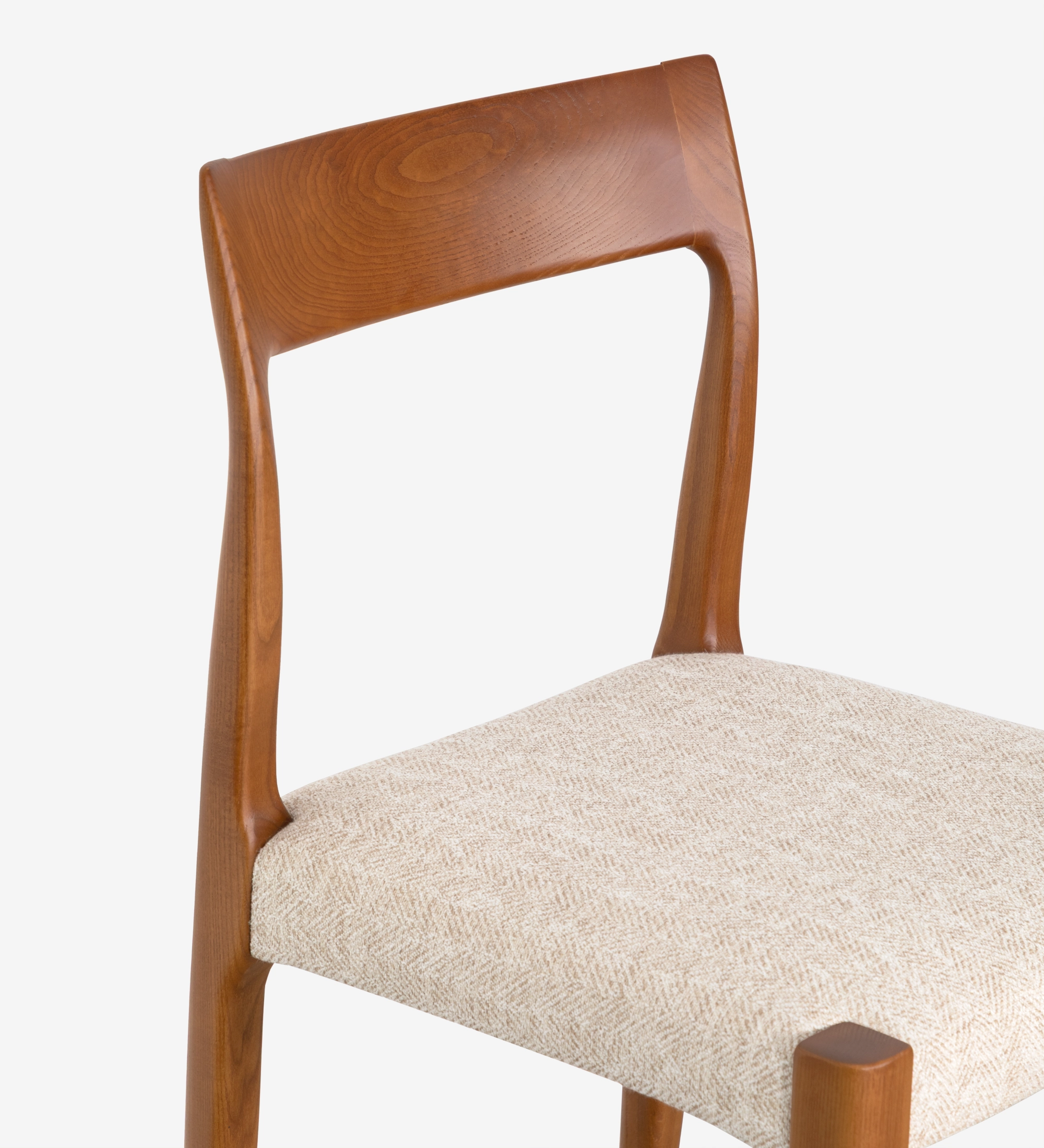 Chair in honey colored ash wood with beige fabric upholstered seat.