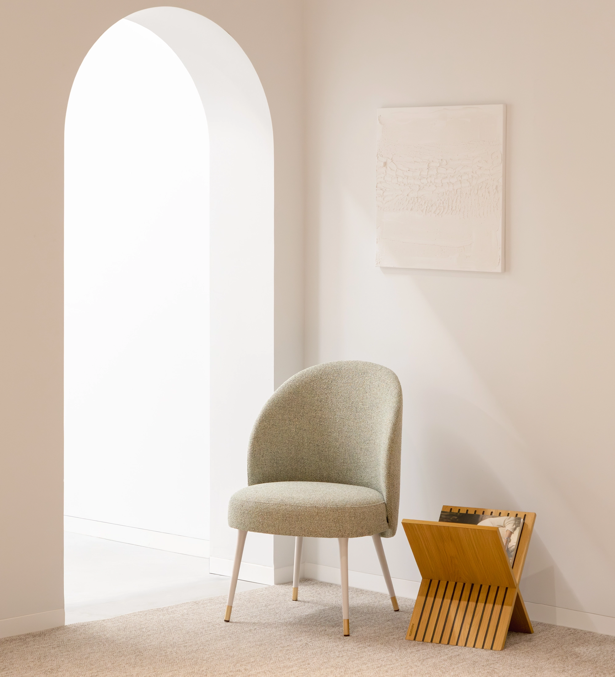 Geneve armchair upholstered in green fabric, pearl lacquered feet and golden detail.