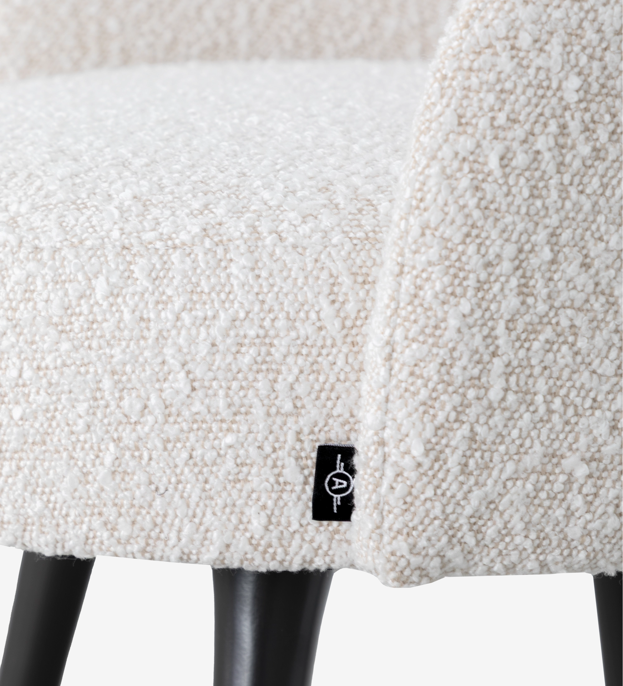 Pearl fabric upholstered swivel chair with black lacquered legs and gold detailing.