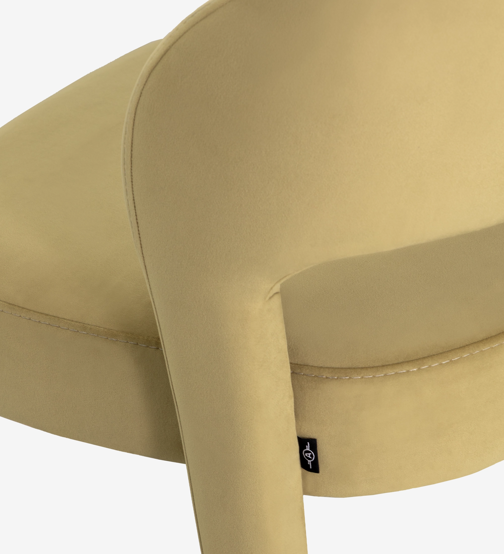 Mónaco Chair close-up of beige velvet seat and curved arm with stitched seam