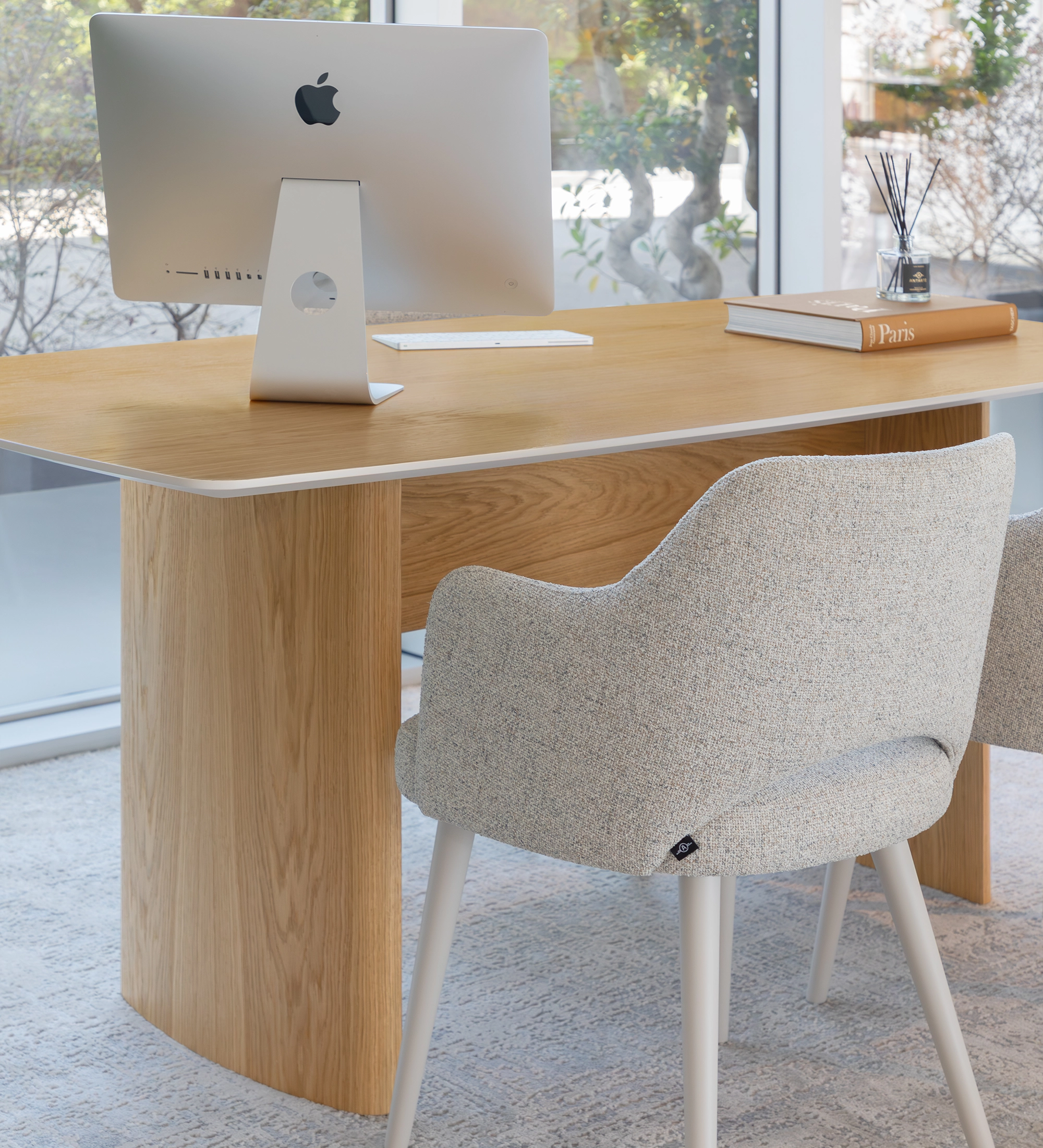 Paris Desk oak table with iMac, upholstered chair and book near window
