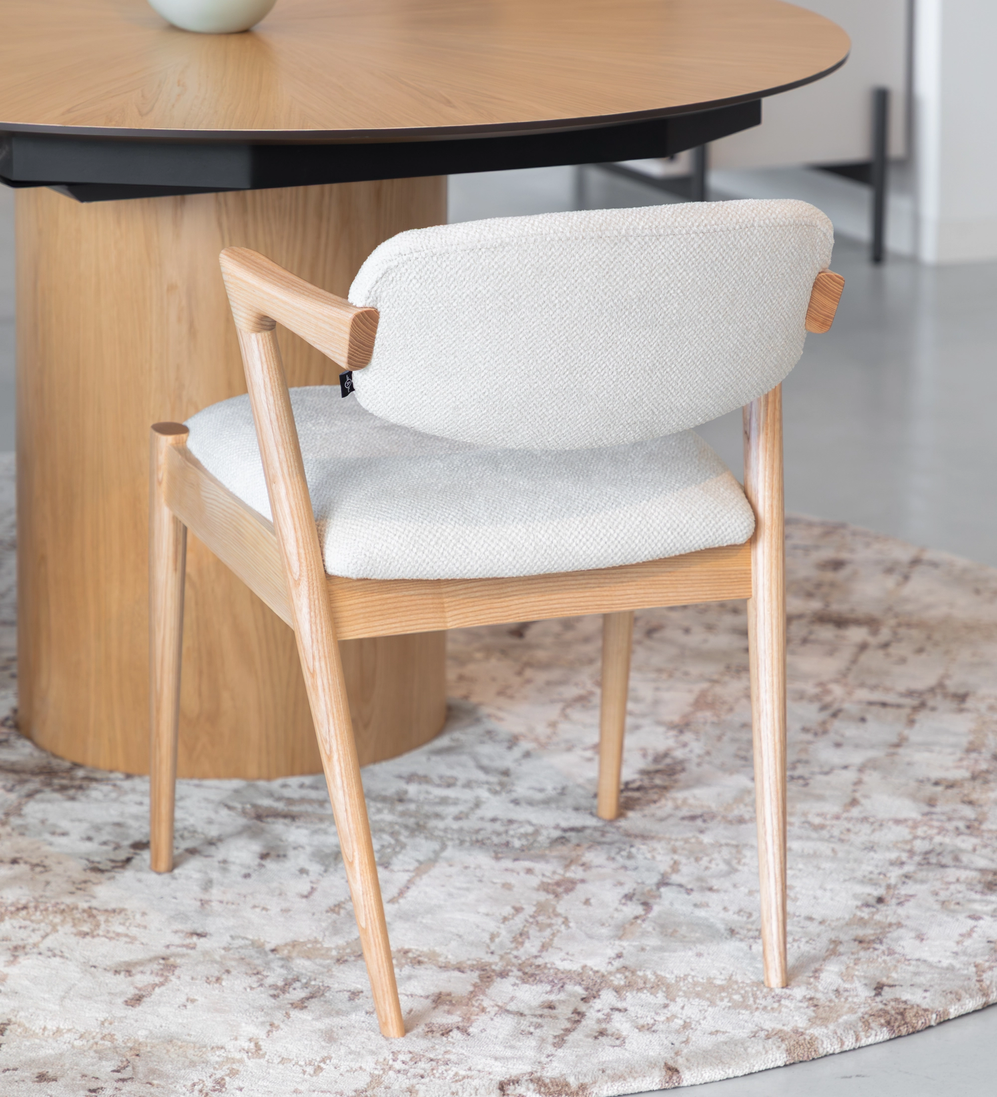 Elba Chair with white textured upholstery and light oak frame, rear view