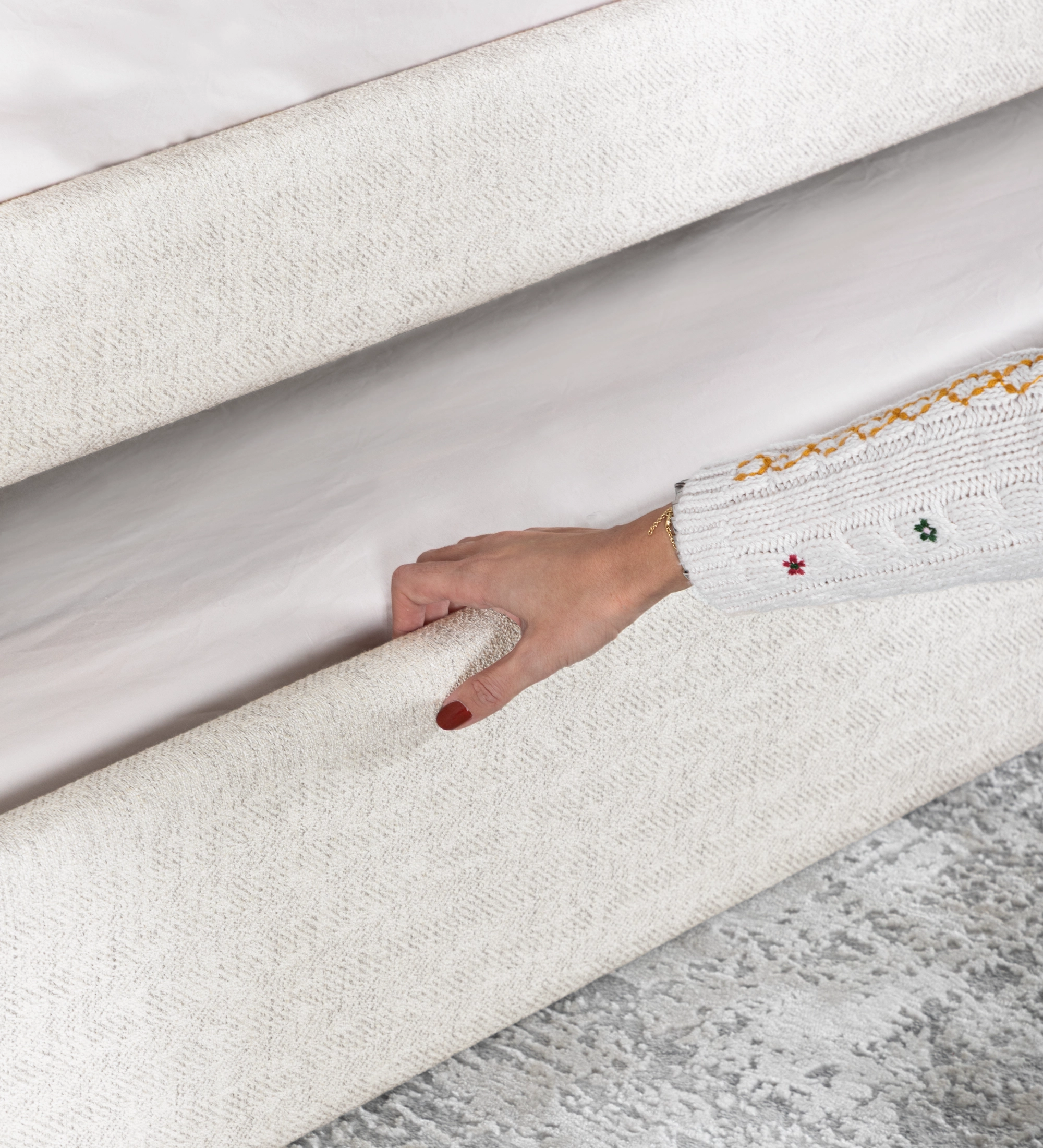 Divan Bed with upholstered frame and front in pearl fabric, featuring a bed in the lower drawer.