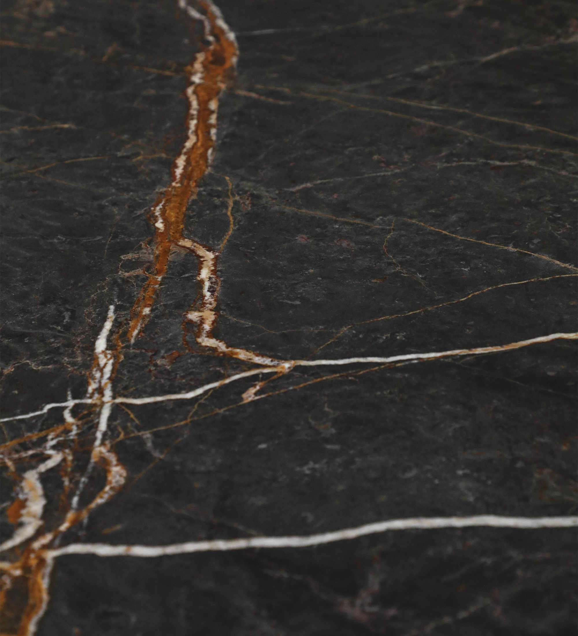 Lagos Dining Table dark marble top with white and rust-colored veining