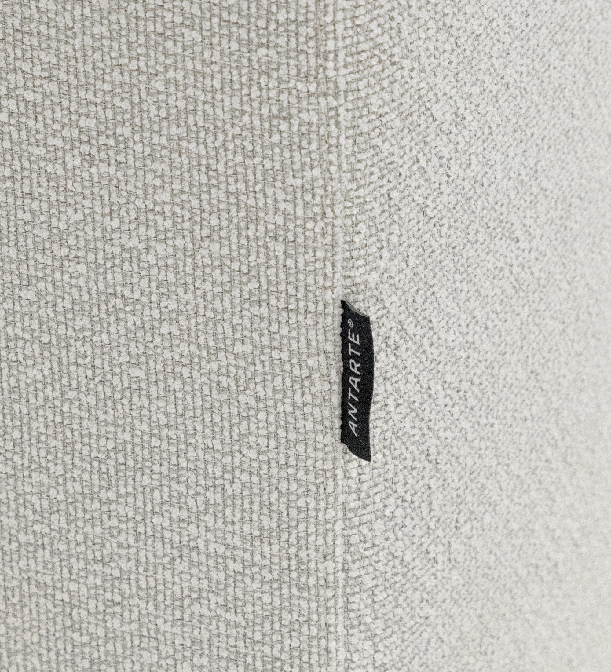 Lagos Sofa with Chaise Longue close-up of beige textured upholstery and fabric brand tag