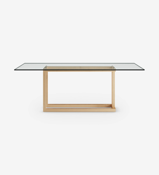 Rectangular dining table with glass top and gold lacquered metal foot.