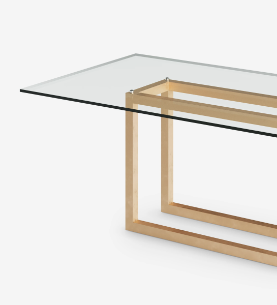 Rectangular dining table with glass top and gold lacquered metal foot.