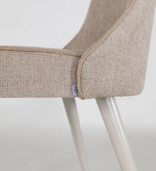 Fabric upholstered chair with pearl lacquered feet.
