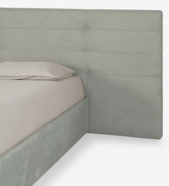 Double bed with long headboard, upholstered in fabric, with storage via lift-up bed frame.