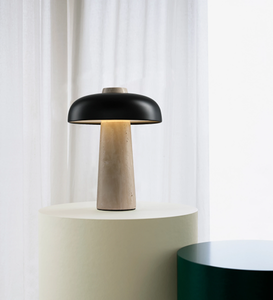 Table lamp with beige stone base and black aluminum lampshade.