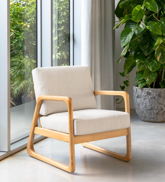 Antarte by AI Armchair upholstered in light gray fabric, structure in natural wood.