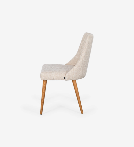 Oslo chair upholstered in beige fabric and honey-colored wooden legs.