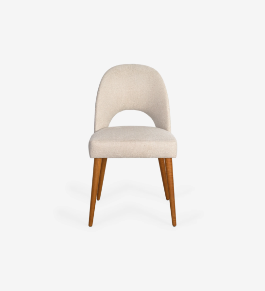 Chair upholstered in fabric, with honey-colored wooden legs.