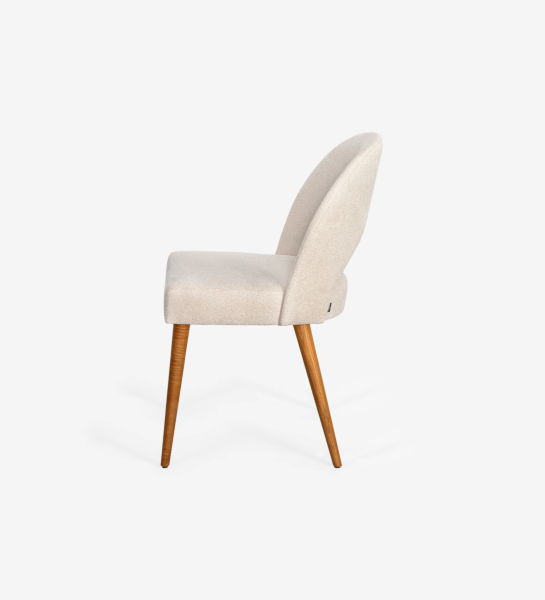 Chair upholstered in fabric, with honey-colored wooden legs.