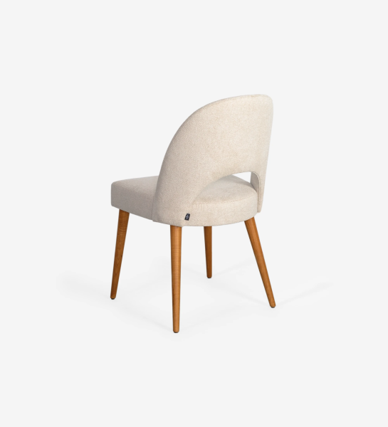 Chair upholstered in fabric, with honey-colored wooden legs.