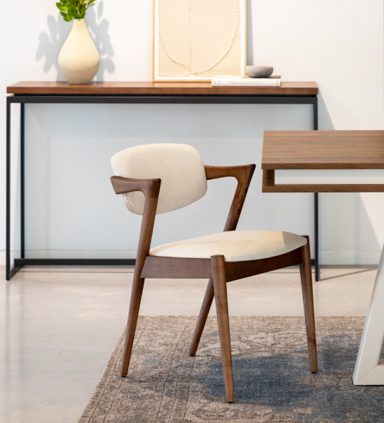 Chair in walnut-colored ash wood, with seat and back upholstered in fabric.