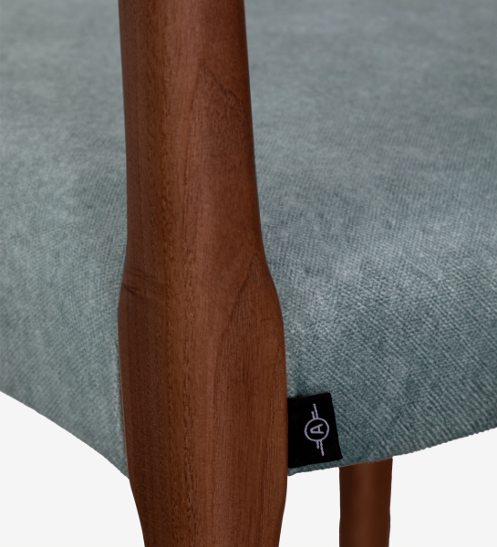 Walnut colored wooden chair with seat upholstered in blue fabric.