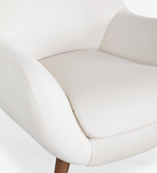 Oslo armchair upholstered in pearl fabric with walnut-stained ash wood legs.