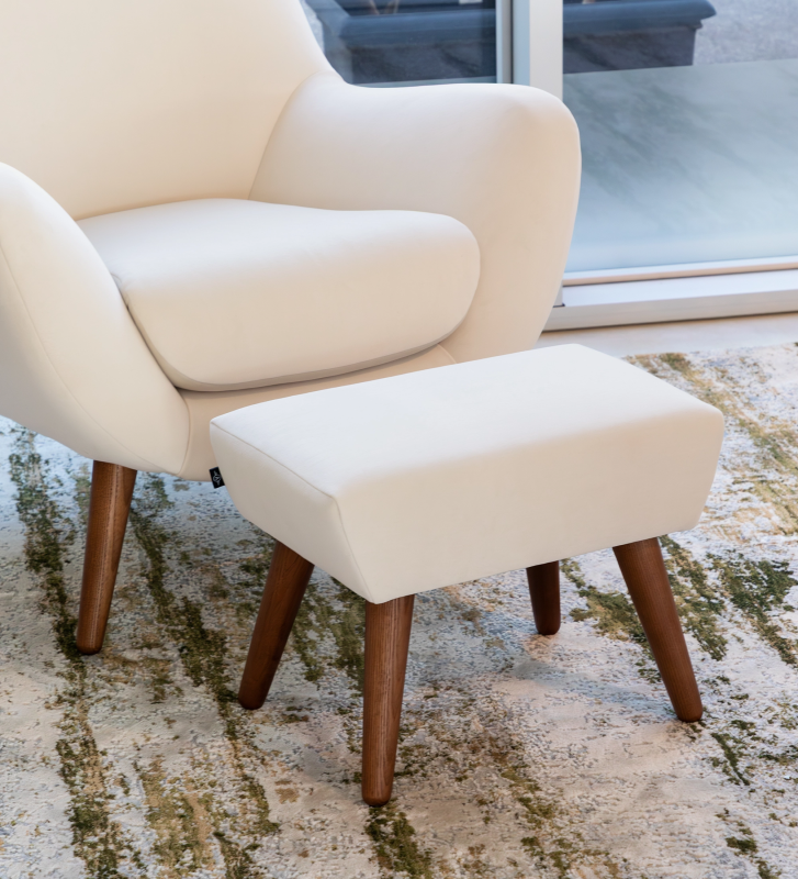 Upholstered in pearl fabric with walnut-colored ash wood legs.