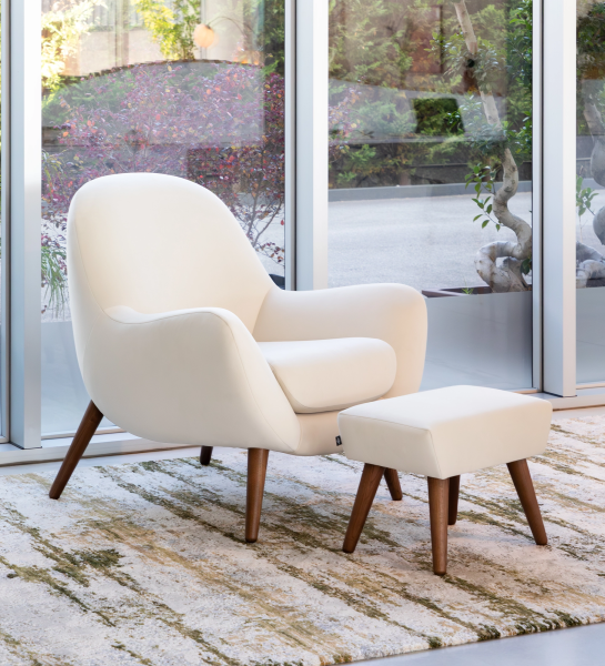 Upholstered in pearl fabric with walnut-colored ash wood legs.