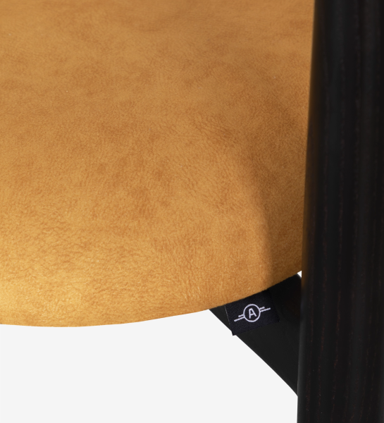 Ash wood chair in wenge color, with seat and backrest upholstered in yellow fabric.