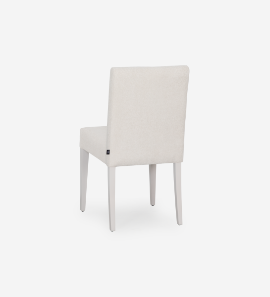 Chaise rembourrée en tissu, pieds laqués perle.