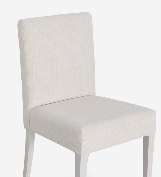 Chaise rembourrée en tissu, pieds laqués perle.
