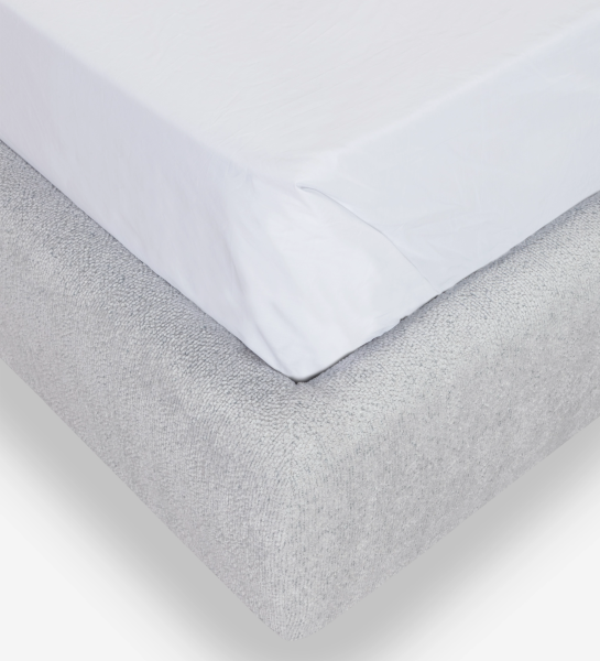 Double bed with short headboard, upholstered in grey fabric.