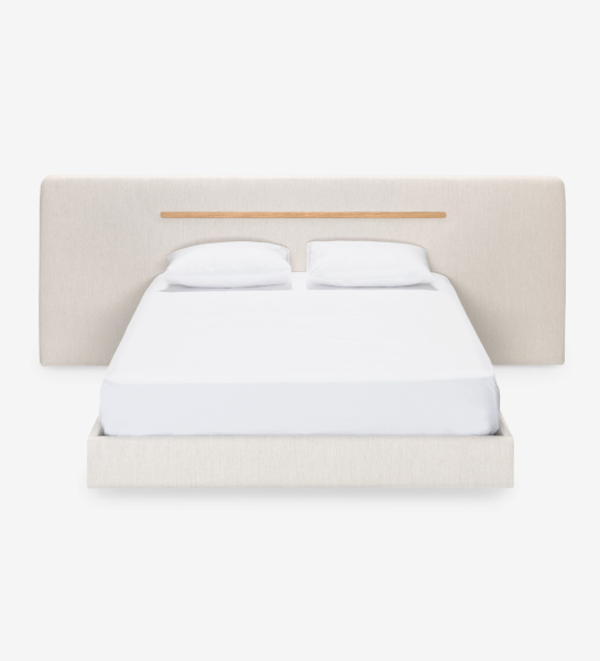 Double bed with upholstered headboard and suspended base in beige fabric, detailed in natural oak.
