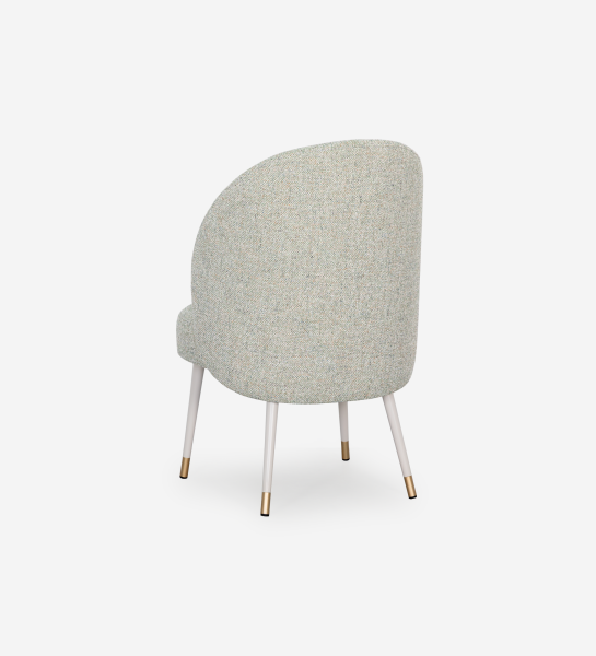 Geneve armchair upholstered in green fabric, pearl lacquered feet and golden detail.