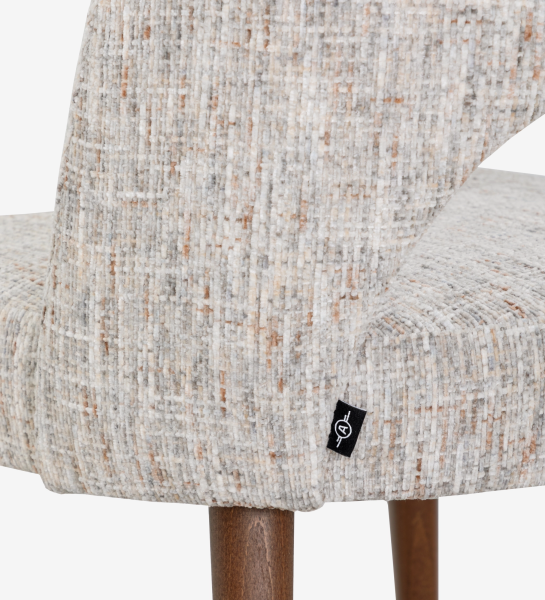 Paris Chair close-up of beige textured upholstery and walnut-finish wooden legs