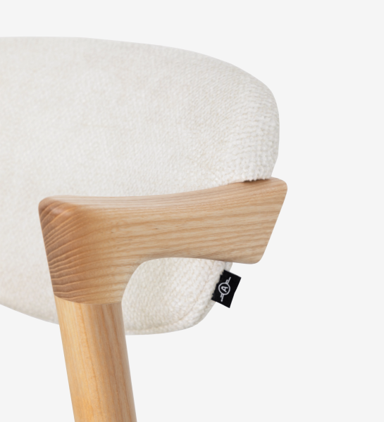 Elba Chair close-up of light wood armrest and cream textured fabric back