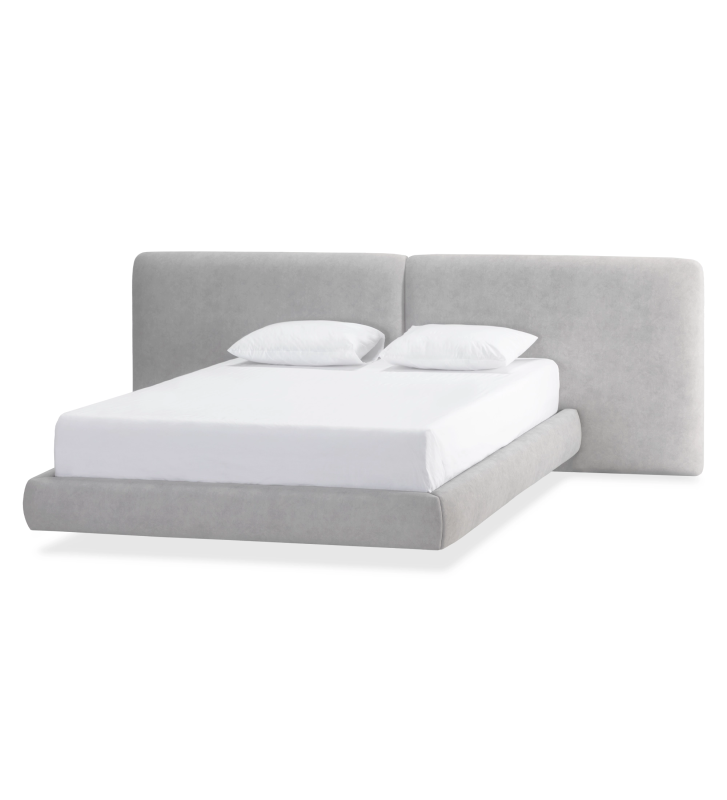 Cama de matrimonio con cabecero dividido y pie de cama suspendido, tapizada en tejido gris.