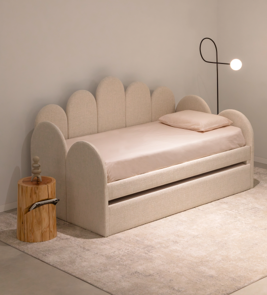 Divan Bed with upholstered frame and front in pearl fabric, featuring a bed in the lower drawer.