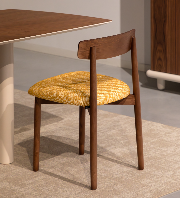 Walnut colored wood chair with yellow fabric upholstered seat